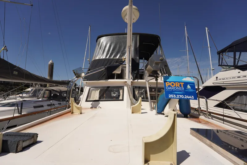 Slide: The Image of 1986 Ocean Alexander 40 Double Cabin yacht docked at marina under clear blue sky. - 5