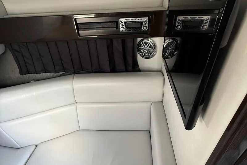 Slide: The Image of Interior of 2018 Formula 330 Crossover Bowrider with white seating and audio system. - 13