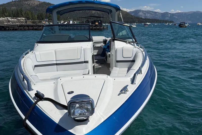 Slide: The Image of 2018 Formula 330 Crossover Bowrider on a scenic lake with mountains in the background. - 2