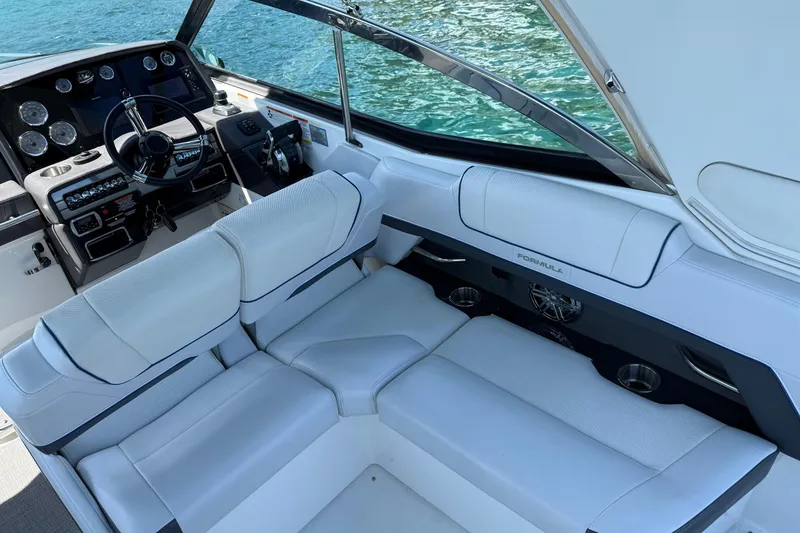 Slide: The Image of 2018 Formula 330 Crossover Bowrider interior with white seating and modern dashboard. - 3