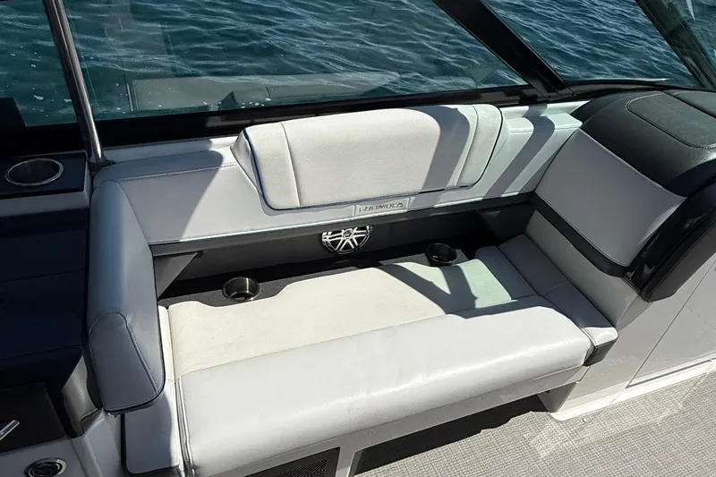 Slide: The Image of 2018 Formula 330 Crossover Bowrider interior seating with cup holders, on water. - 8