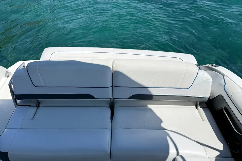 Slide: The Image of 2018 Formula 330 Crossover Bowrider with white seating, overlooking clear blue water. - 9