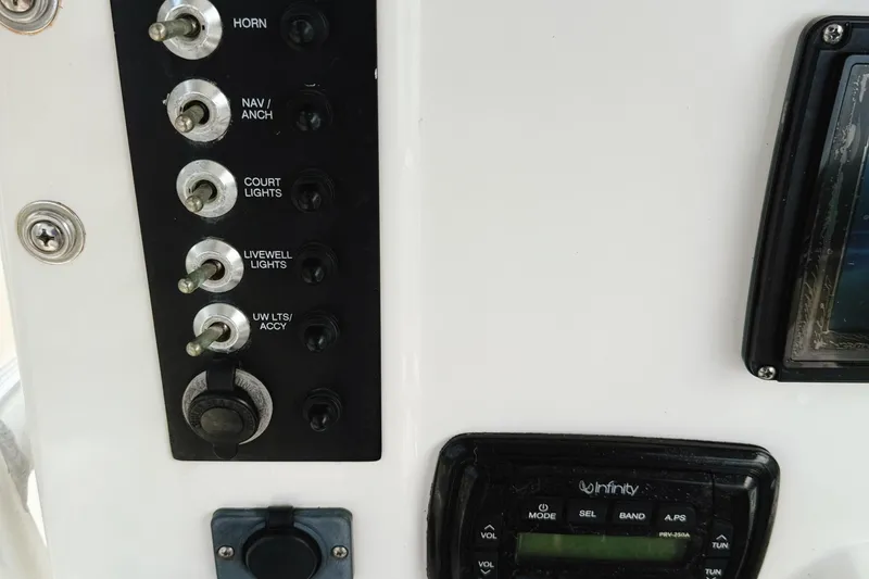 Slide: The Image of Control panel of a 2016 Robalo R222 Center Console boat with switches and display. - 11