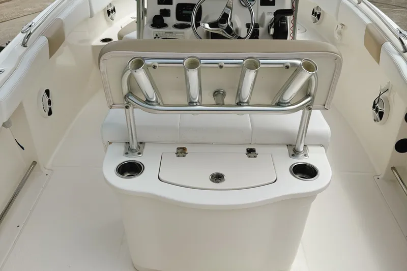 Slide: The Image of 2016 Robalo R222 Center Console boat interior with rod holders and steering wheel. - 14