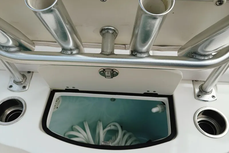 Slide: The Image of 2016 Robalo R222 Center Console boat with rod holders and storage compartment. - 15