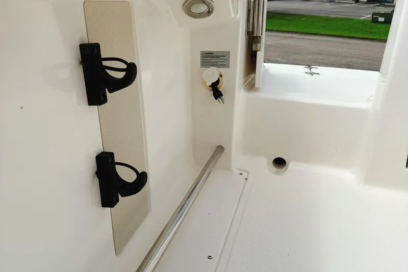 Slide: The Image of 2016 Robalo R222 Center Console interior detail with rod holders and clean white deck. - 16