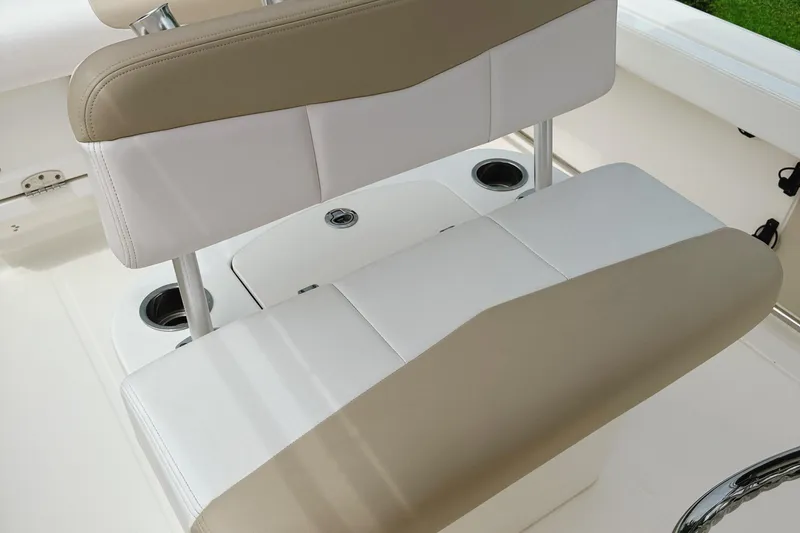 Slide: The Image of 2016 Robalo R222 Center Console boat seat with beige and white upholstery. - 18