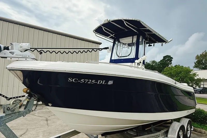 Slide: The Image of 2016 Robalo R222 Center Console boat on trailer, parked outdoors. - 2