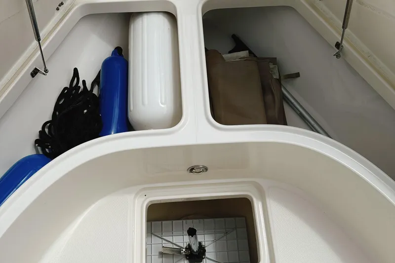 Slide: The Image of 2016 Robalo R222 Center Console storage compartment with ropes and fenders. - 20