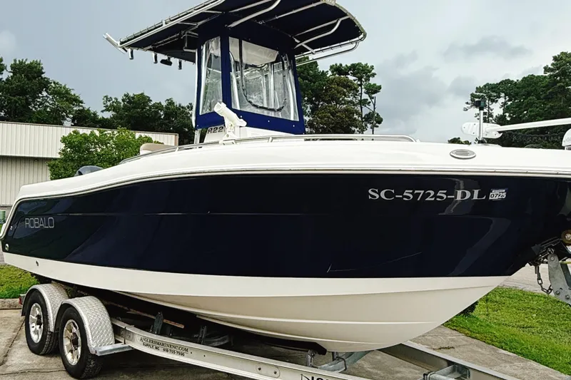 Slide: The Image of 2016 Robalo R222 Center Console boat on trailer, parked outdoors. - 3