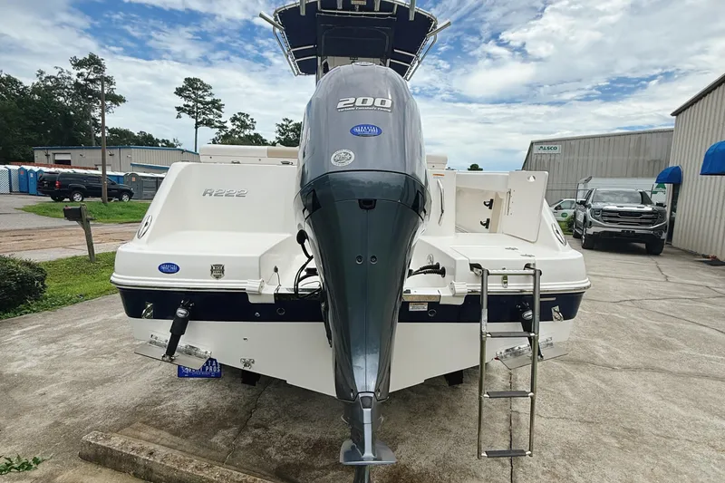 Slide: The Image of 2016 Robalo R222 Center Console boat with 200 HP engine, parked outdoors. - 5