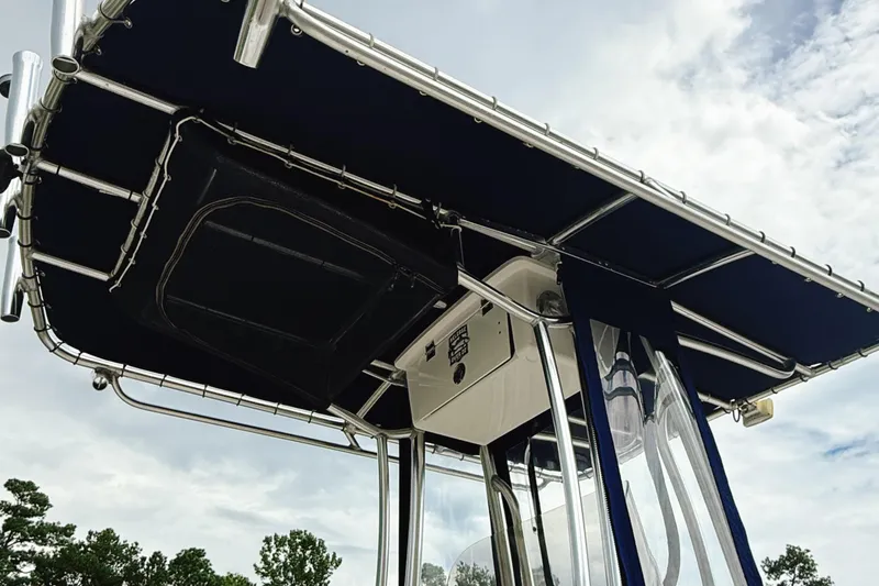 Slide: The Image of 2016 Robalo R222 Center Console boat with T-top canopy against cloudy sky. - 6