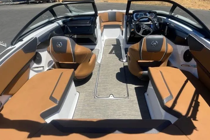 Slide: The Image of 2022 Scarab 215 SE boat interior with tan seating and modern dashboard. - 11