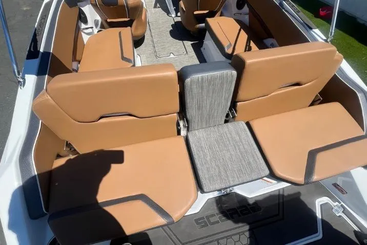 Slide: The Image of 2022 Scarab 215 SE boat interior with tan seating and modern design. - 12