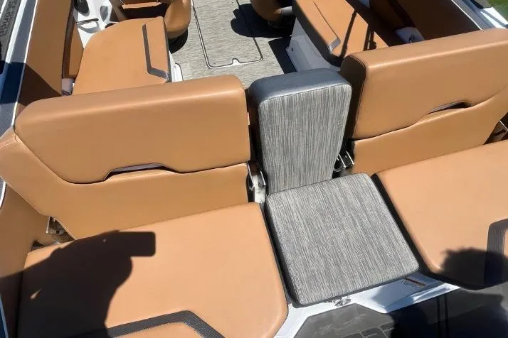 Slide: The Image of 2022 Scarab 215 SE boat interior with tan seating and gray accents. - 13