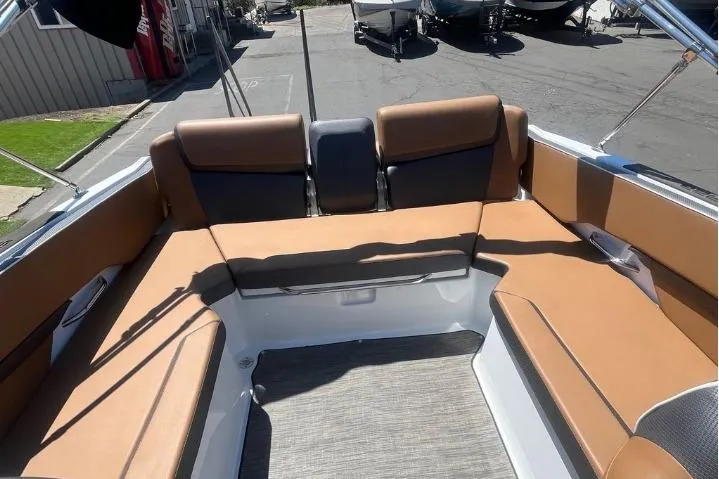 Slide: The Image of 2022 Scarab 215 SE boat interior with tan seating and spacious layout. - 14