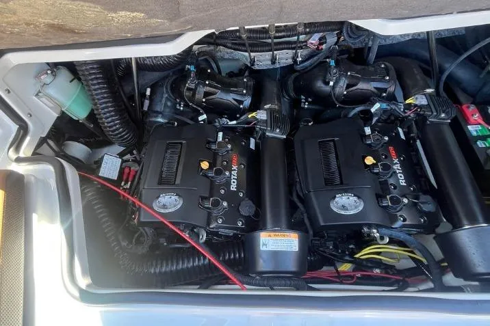 Slide: The Image of 2022 Scarab 215 SE engine compartment with dual Rotax engines, showcasing intricate wiring and components. - 15