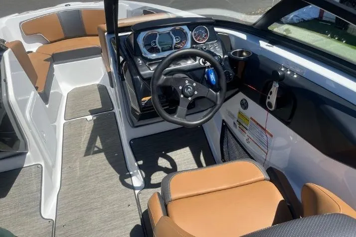Slide: The Image of 2022 Scarab 215 SE boat interior with modern dashboard and tan seating. - 19