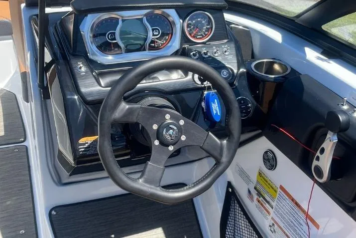 Slide: The Image of 2022 Scarab 215 SE boat dashboard with steering wheel and instrument panel. - 20
