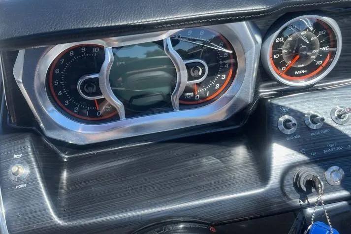 Slide: The Image of Dashboard of a 2022 Scarab 215 SE boat with speedometer and controls. - 21