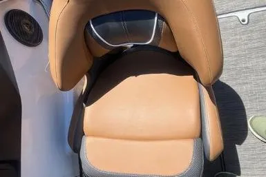 Slide: The Image of 2022 Scarab 215 SE boat seat with tan upholstery and modern design. - 23