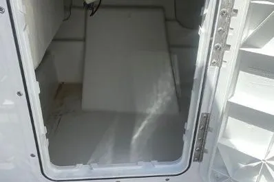 Slide: The Image of 2022 Scarab 215 SE storage compartment with open hatch, showcasing interior space. - 26
