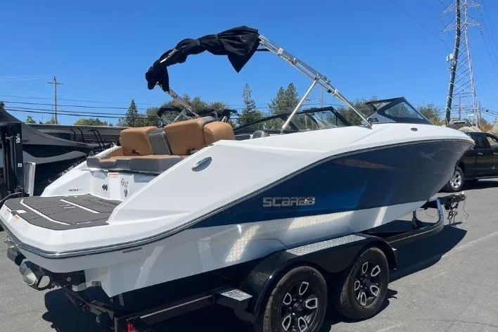 Slide: The Image of 2022 Scarab 215 SE boat on trailer, featuring sleek design and modern amenities. - 29