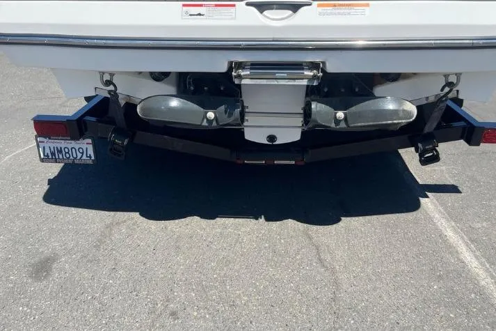 Slide: The Image of Rear view of a 2022 Scarab 215 SE boat on a trailer in a parking lot. - 7