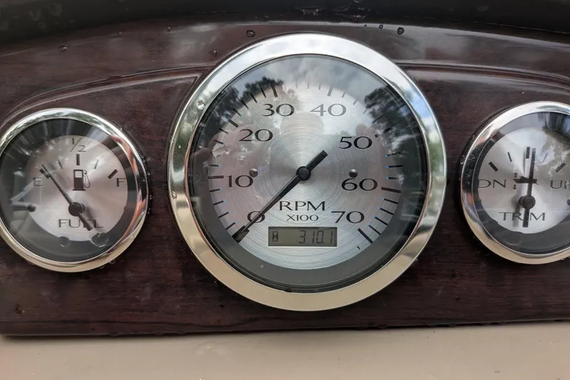 Slide: The Image of Dashboard gauges of a 2012 Bennington 2574 GCW boat, showing fuel, RPM, and trim levels. - 3