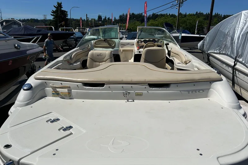 Slide: The Image of 2000 Sea Ray 185 Bow Rider boat with beige interior, parked outdoors. - 12