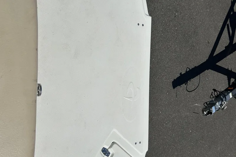 Slide: The Image of 2000 Sea Ray 185 Bow Rider boat deck with trailer hitch on asphalt. - 13