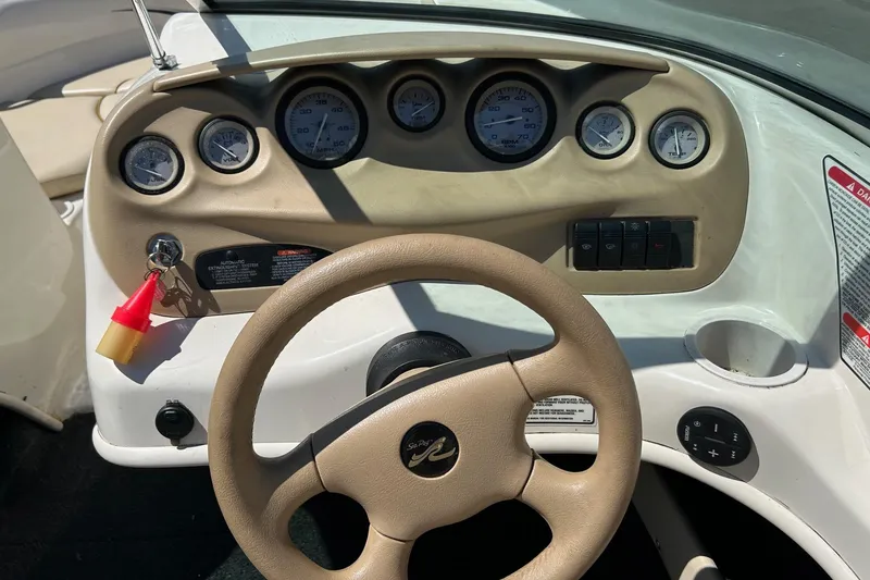 Slide: The Image of Dashboard of a 2000 Sea Ray 185 Bow Rider boat with gauges and steering wheel. - 6