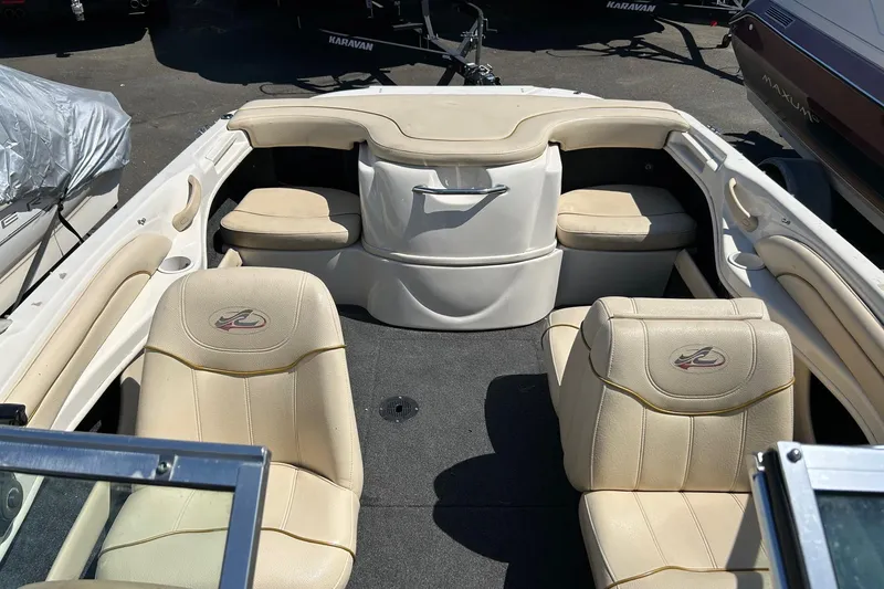 Slide: The Image of 2000 Sea Ray 185 Bow Rider interior with beige seating and storage compartments. - 9