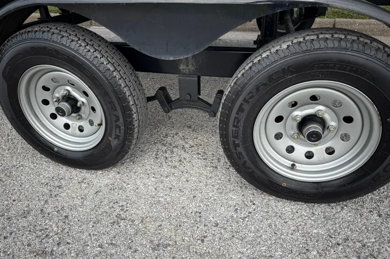 Slide: The Image of 2018 Sweetwater Sunrise 206 F pontoon boat on trailer by a lake. - 11