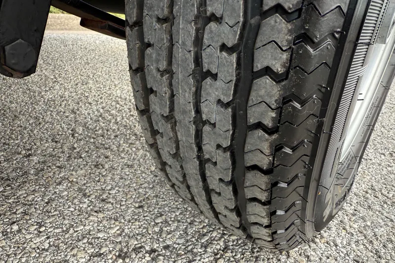 Slide: The Image of 2018 Sweetwater Sunrise 206 F pontoon boat on trailer, with Yamaha motor, under clear sky. - 13