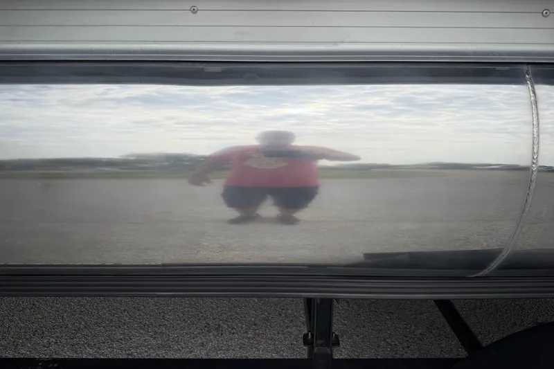 Slide: The Image of 2018 Sweetwater Sunrise 206 F pontoon boat on trailer by a lake. - 14