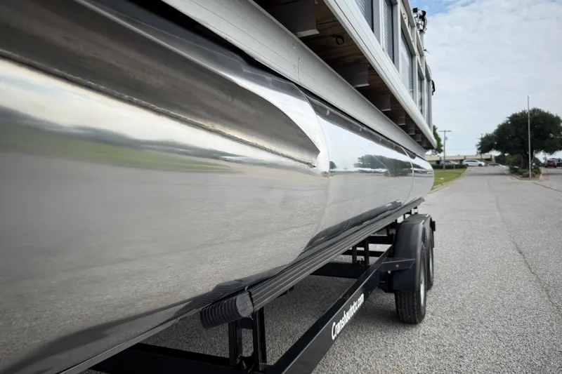 Slide: The Image of 2018 Sweetwater Sunrise 206 F pontoon boat on trailer by a lake. - 15