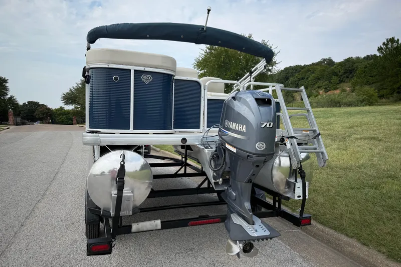 Slide: The Image of 2018 Sweetwater Sunrise 206 F pontoon boat on trailer, parked on roadside. - 17