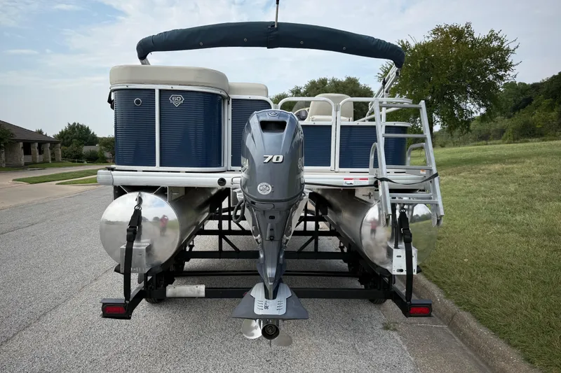 Slide: The Image of 2018 Sweetwater Sunrise 206 F pontoon boat on trailer, parked on roadside. - 18