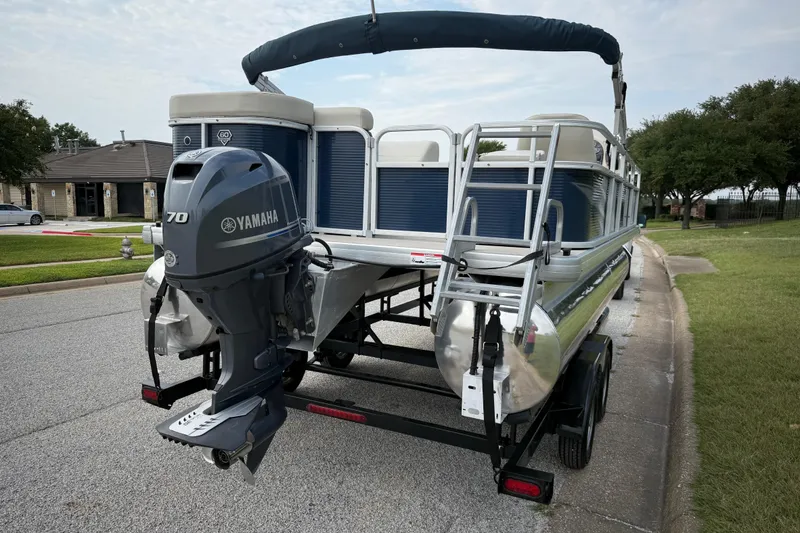 Slide: The Image of 2018 Sweetwater Sunrise 206 F pontoon boat on trailer, parked on roadside. - 19