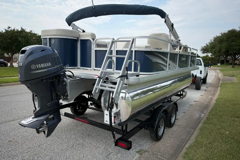 Slide: The Image of 2018 Sweetwater Sunrise 206 F pontoon boat on trailer, parked on roadside. - 20