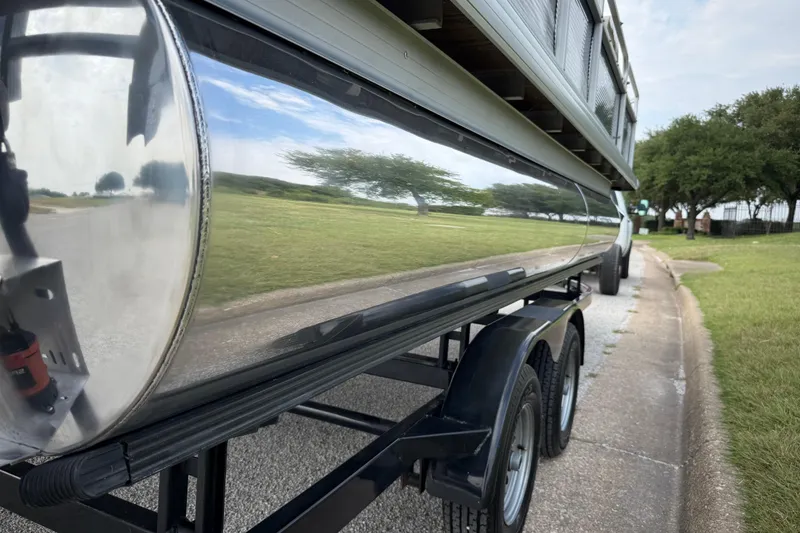 Slide: The Image of 2018 Sweetwater Sunrise 206 F pontoon boat on trailer, parked on roadside. - 21