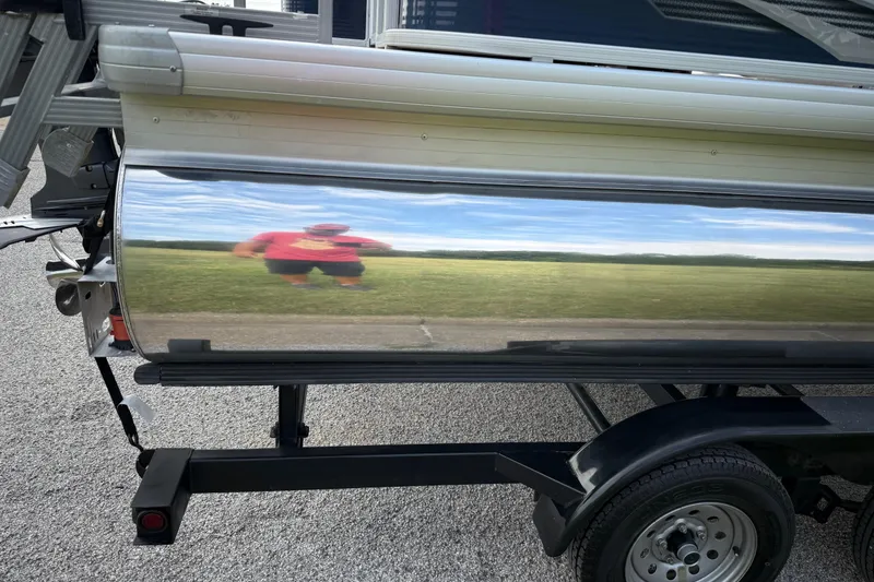 Slide: The Image of 2018 Sweetwater Sunrise 206 F pontoon boat on trailer, parked on a road. - 22
