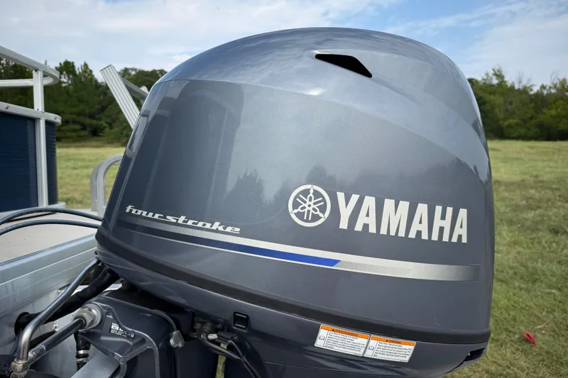 Slide: The Image of 2018 Sweetwater Sunrise 206 F pontoon boat on trailer, parked on roadside. - 23