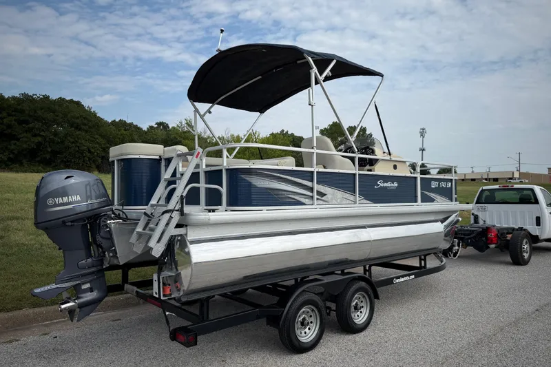 Slide: The Image of 2018 Sweetwater Sunrise 206 F pontoon boat on trailer, reflecting scenic landscape. - 36