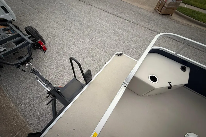 Slide: The Image of 2018 Sweetwater Sunrise 206 F pontoon boat on trailer, parked on roadside. - 45