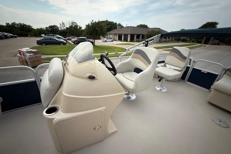 Slide: The Image of 2018 Sweetwater Sunrise 206 F boat with sleek blue and silver design. - 57