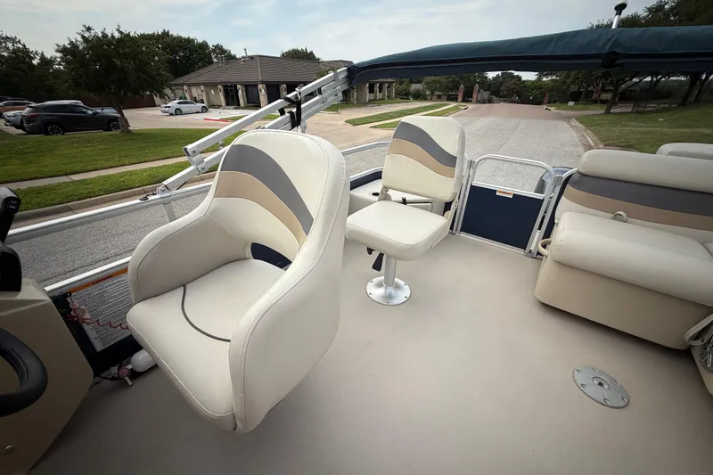 Slide: The Image of 2018 Sweetwater Sunrise 206 F pontoon boat with canopy, parked on a residential street. - 58