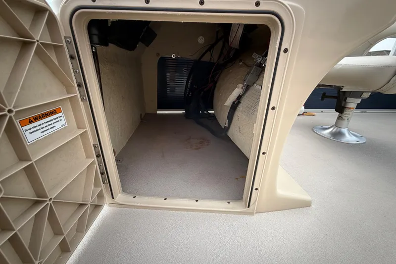 Slide: The Image of 2018 Sweetwater Sunrise 206 F pontoon boat deck with seating and railing, parked on grass. - 59