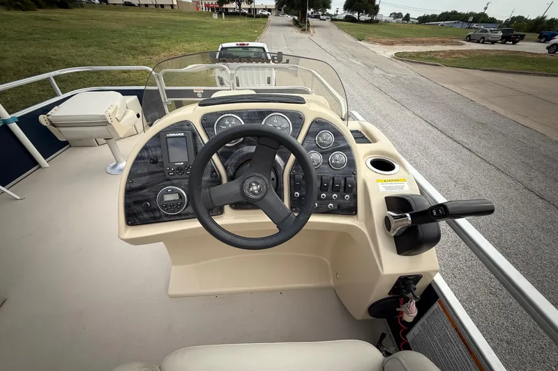 Slide: The Image of 2018 Sweetwater Sunrise 206 F boat trailer hitch and steps on pavement. - 61